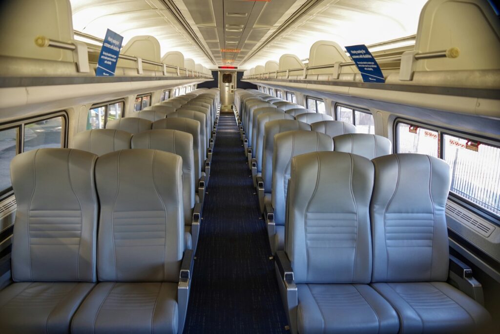 Two rows of leather seats on an Amtrak train.