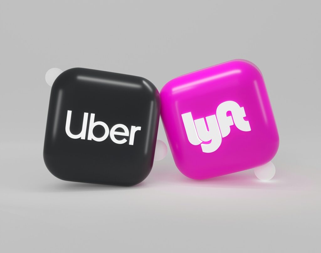 Two tabs - one black with Uber written in white and the other pink with lyft written in white.