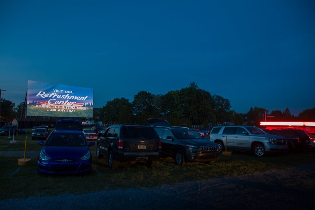 Cars sit in front of a movie screen after sunset at Shanweiler's Drive-in Movie Theatre.