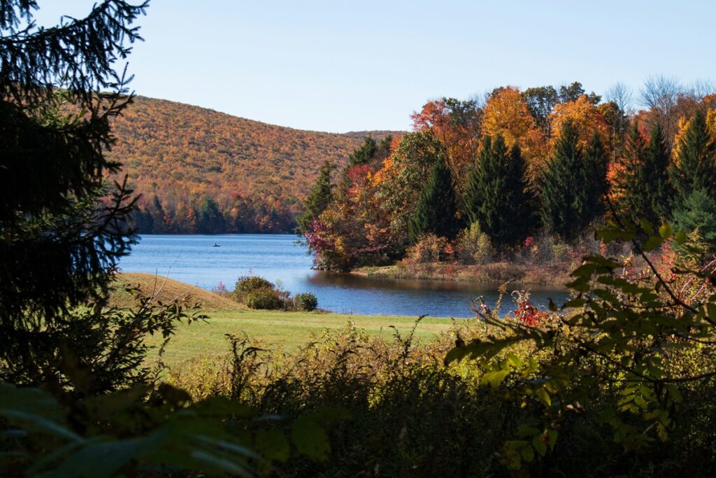 A fall scene in Jim Thorpe. Fall trees surround water.
